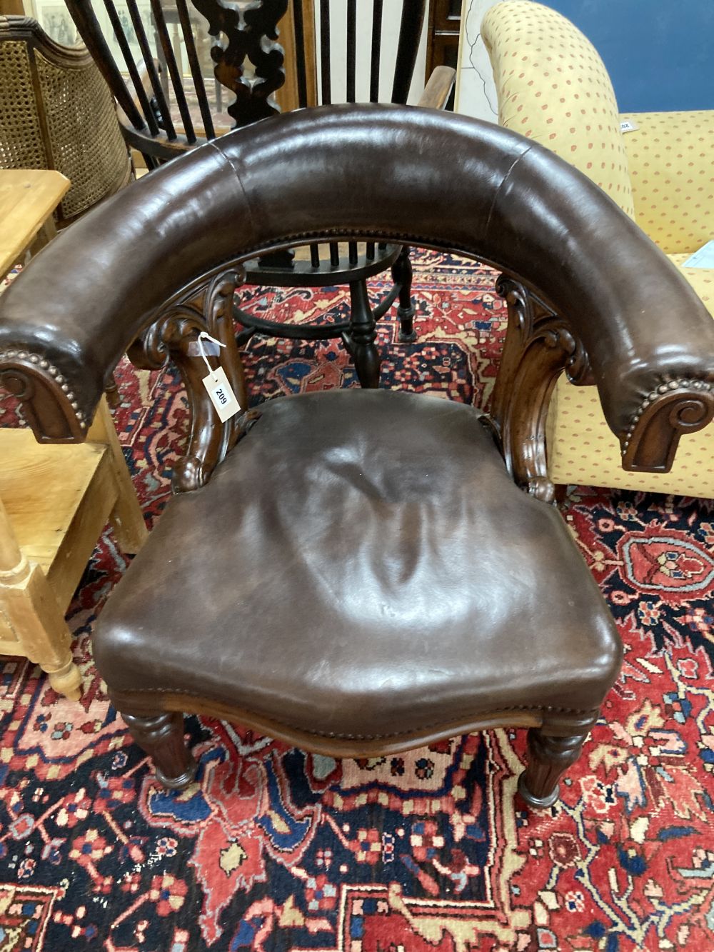 A Victorian mahogany and brown leather library chair